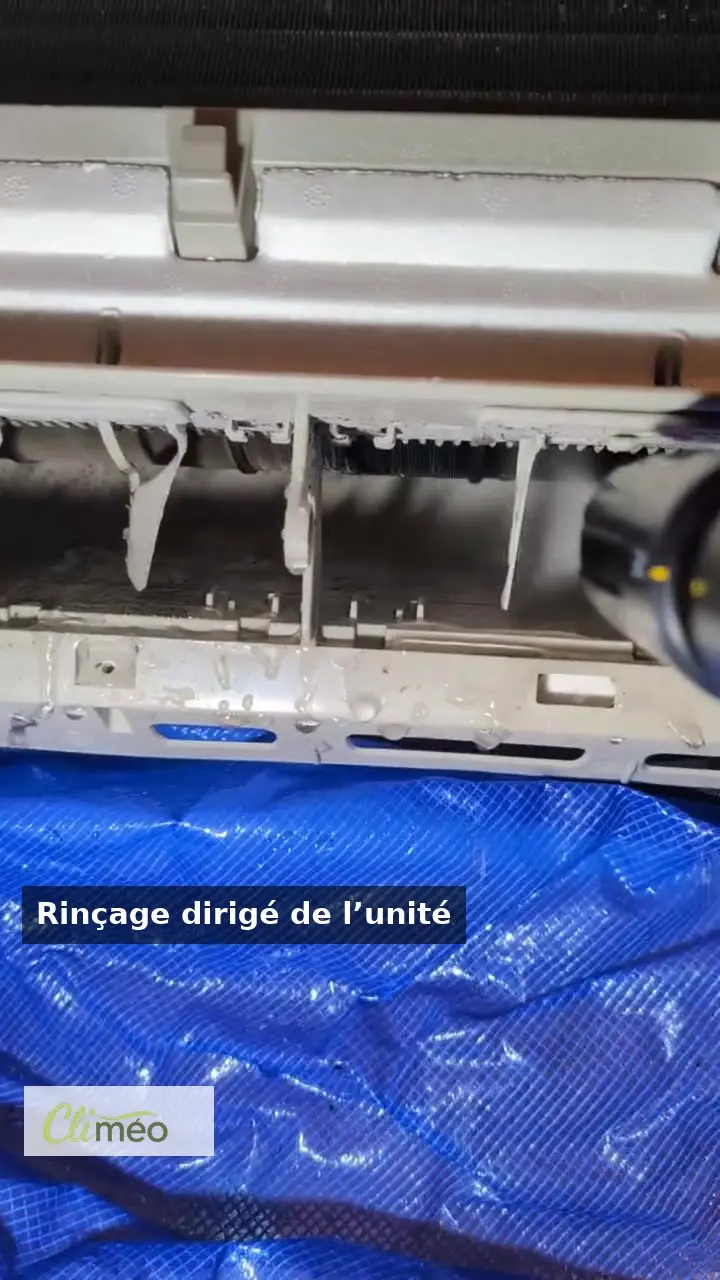 Open wall-mounted air conditioner with a protection bib during a real Climeo cleaning visit