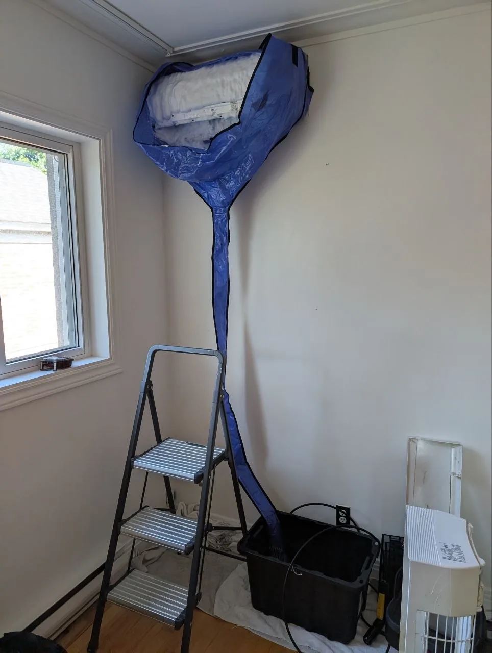 Wall-mounted indoor unit during cleaning.