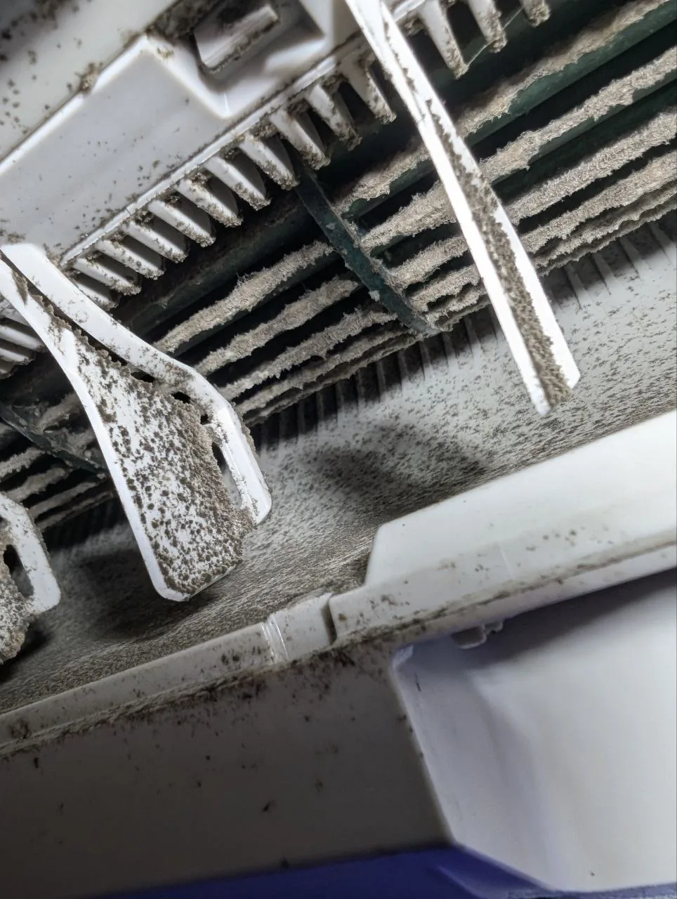 Wall-mounted indoor unit during cleaning.