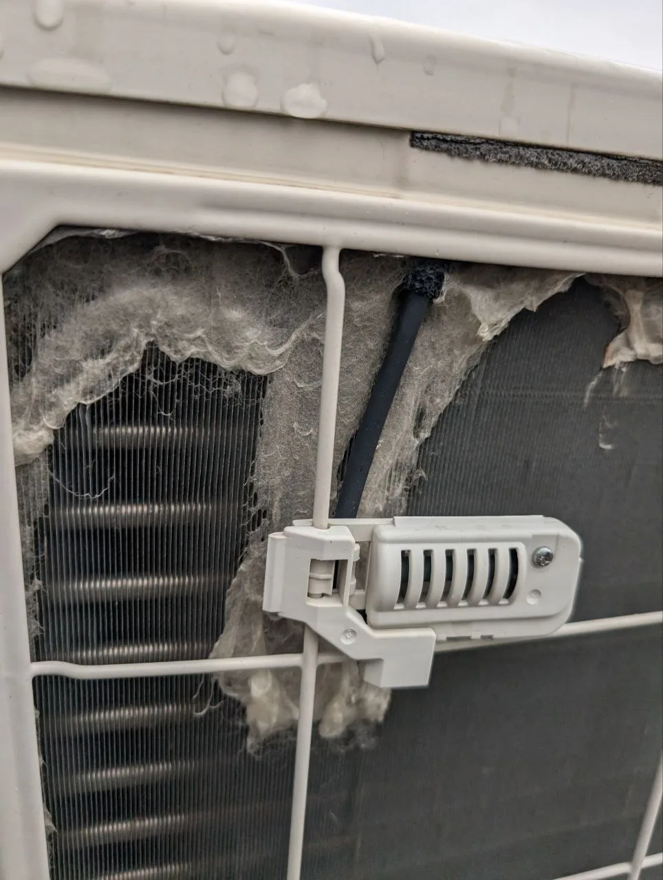Wall-mounted indoor unit during cleaning.